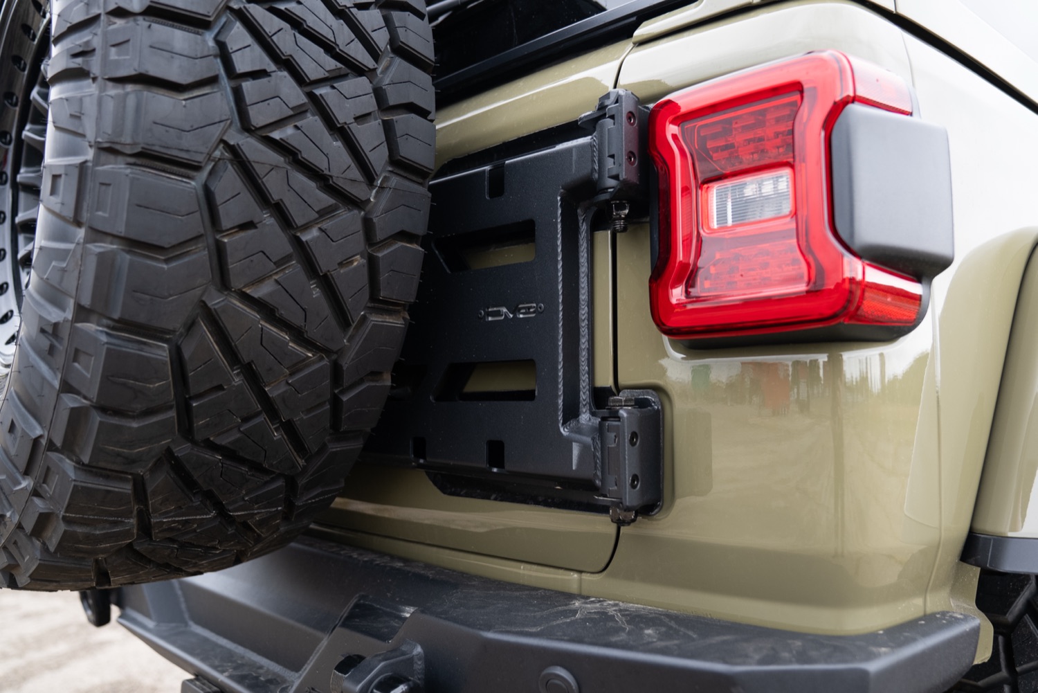 Close view of the Jeep Wrangler rear-mounted spare and carrier