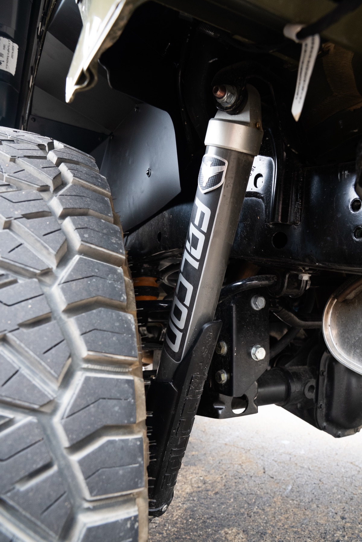 Close view of a Falcon-branded suspension shock behind the Jeep tire