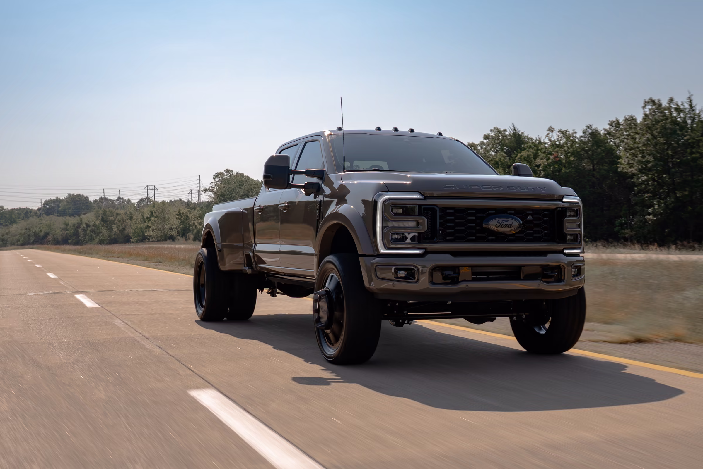 Marsh Gray Ford F-450 Platinum dually driving on the highway after its APG Customs build