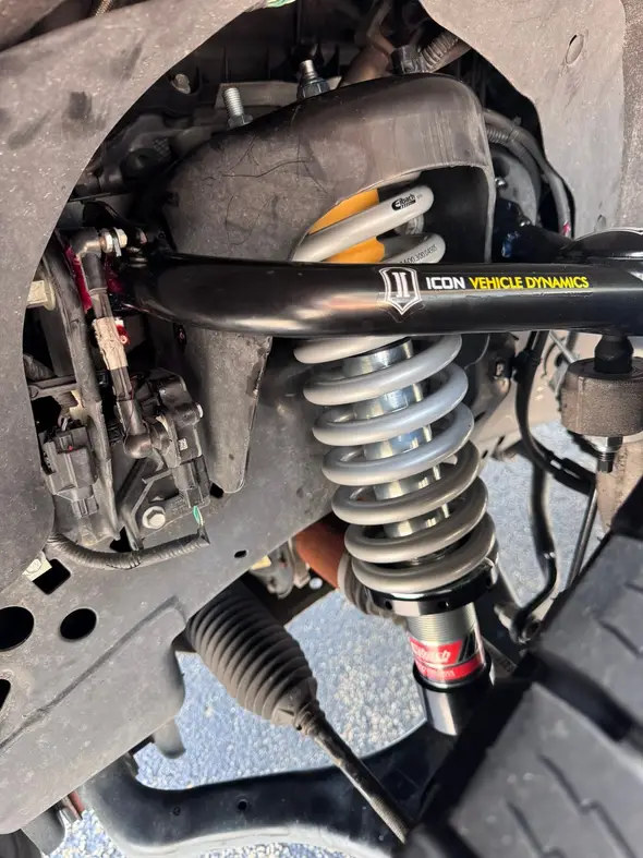 Eibach coilover and black ICON upper control arm photographed inside the F-150 front wheel well
