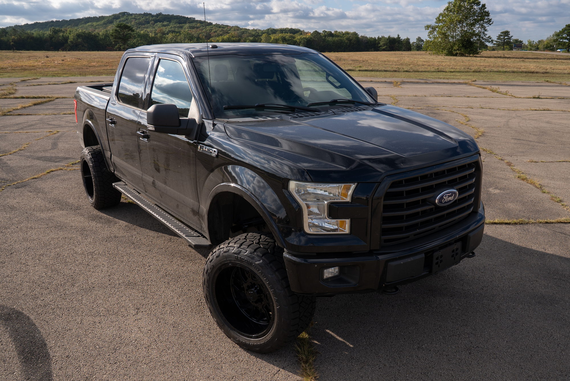 Elevated front three-quarter view of the completed black F-150