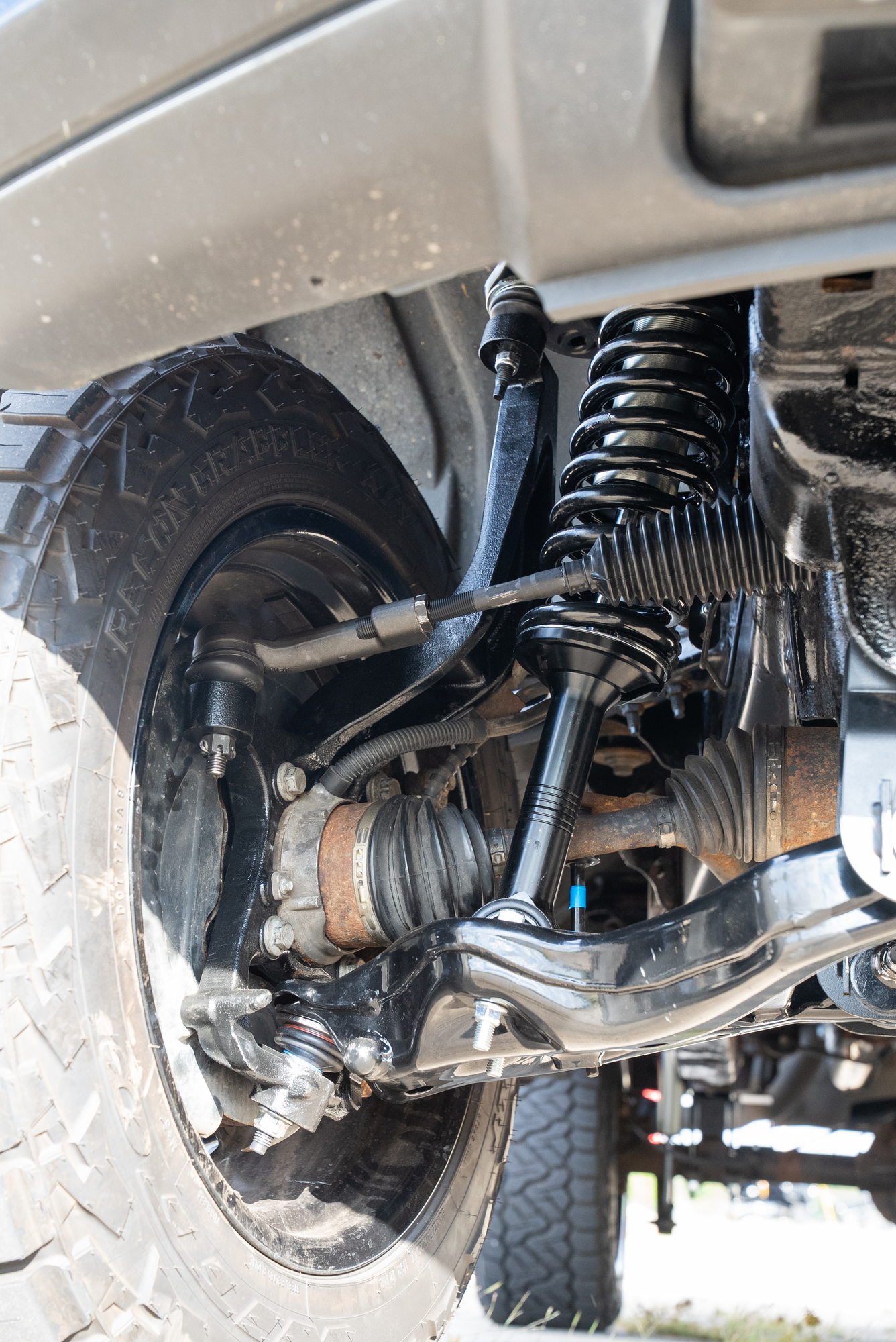 Close view beside the F-150 front wheel showing suspension and steering linkage