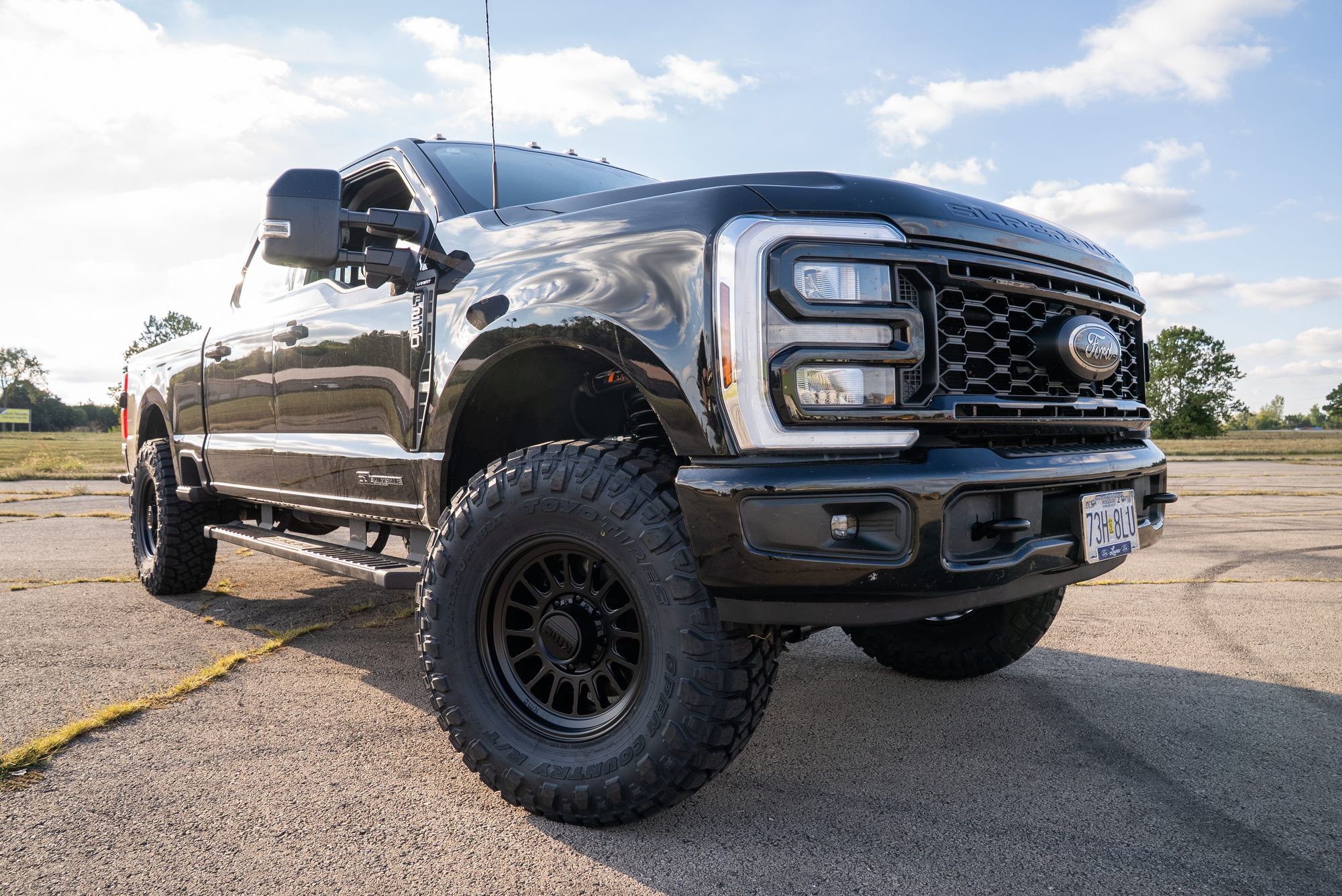 Low front three-quarter view of the completed black Ford F-250 Carli Pathfinder build