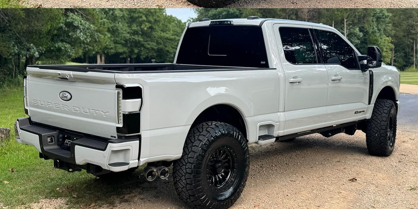 Rear three-quarter view of the same white F-250 Lariat from APG Customs’ August 2025 Instagram post