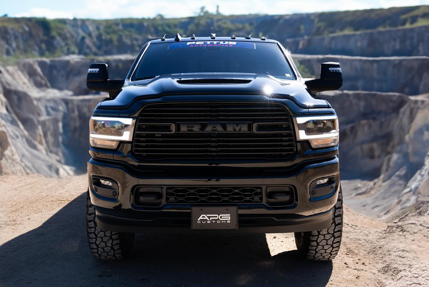 Head-on view of the black APG Ram 2500 Laramie Mega Cab
