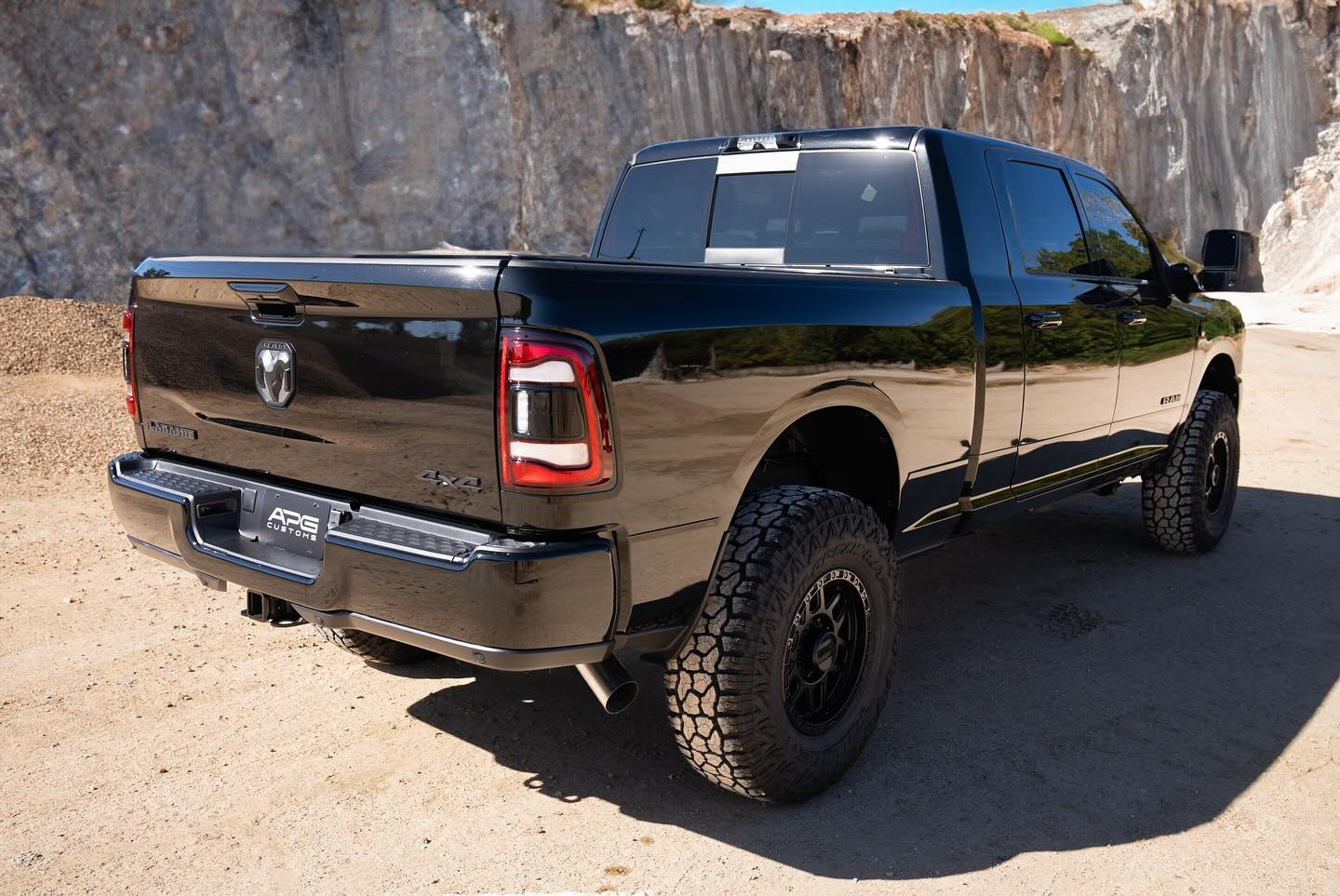Rear three-quarter view of the black APG Ram 2500 Laramie Mega Cab