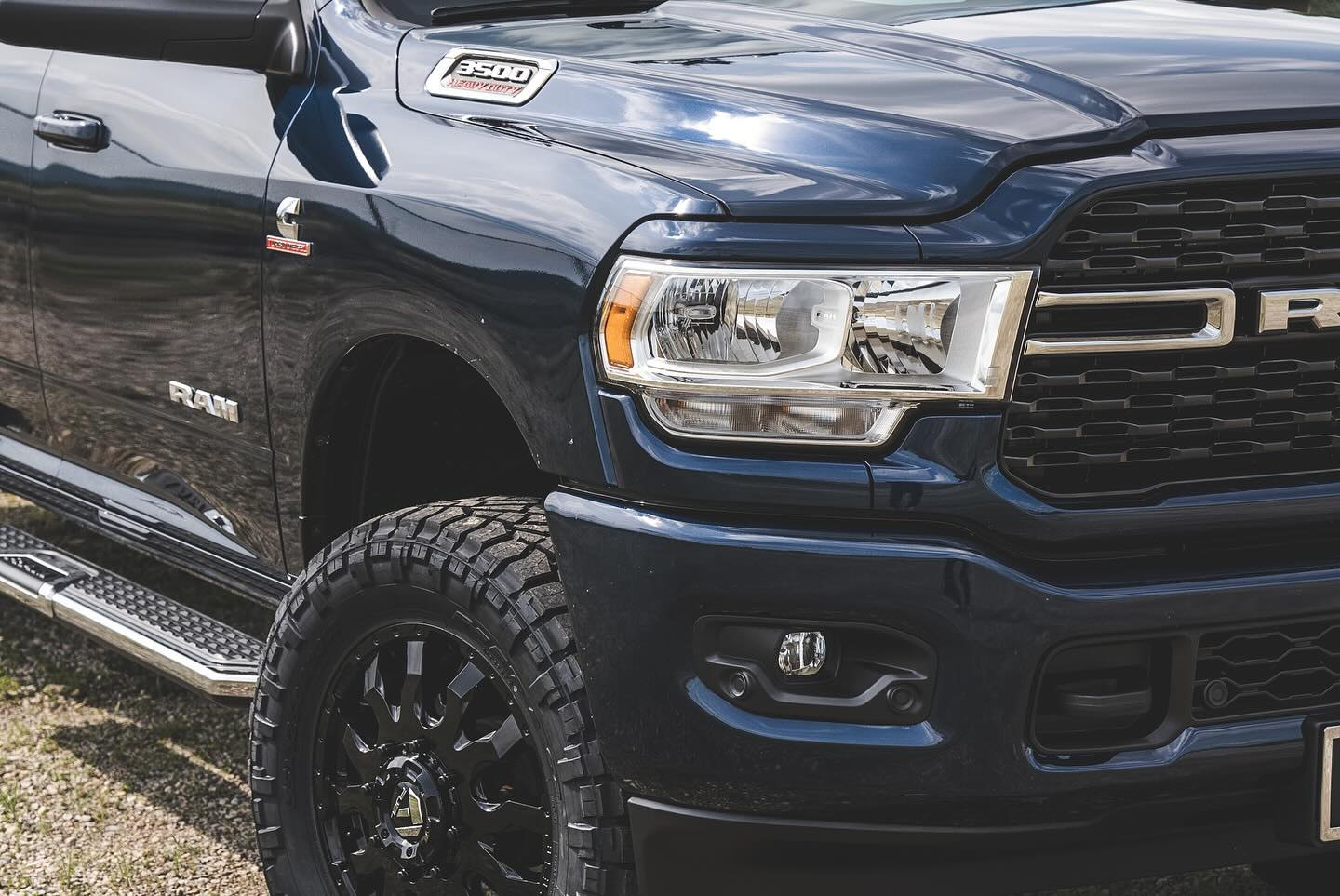 Close-up of the same Ram 3500 Big Horn showing a black Fuel Blitz wheel and Nitto Ridge Grappler tire