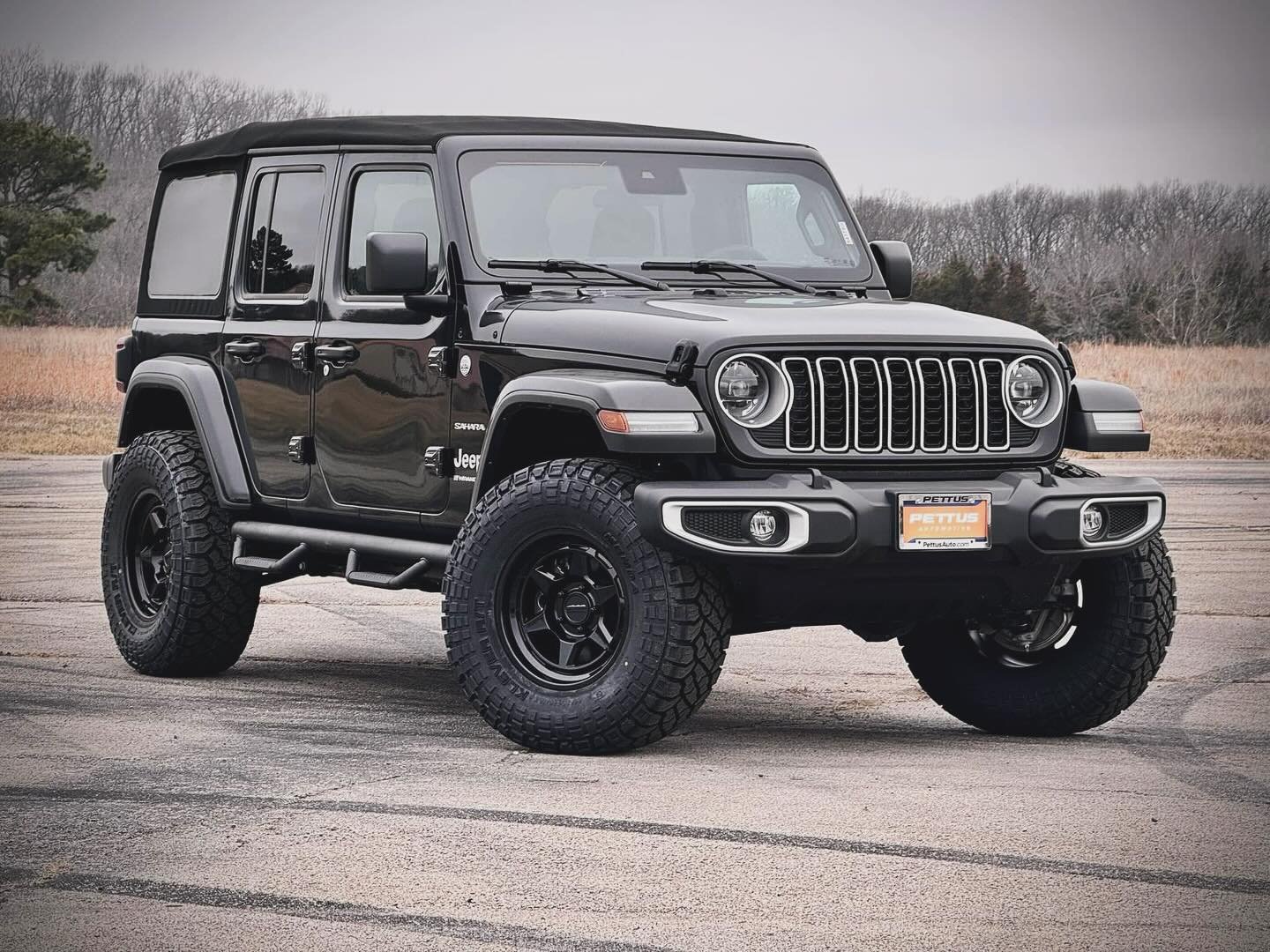 Black 2024 Jeep Wrangler Sahara with a lifted stance, tubular steps, Method wheels and Kenda tires