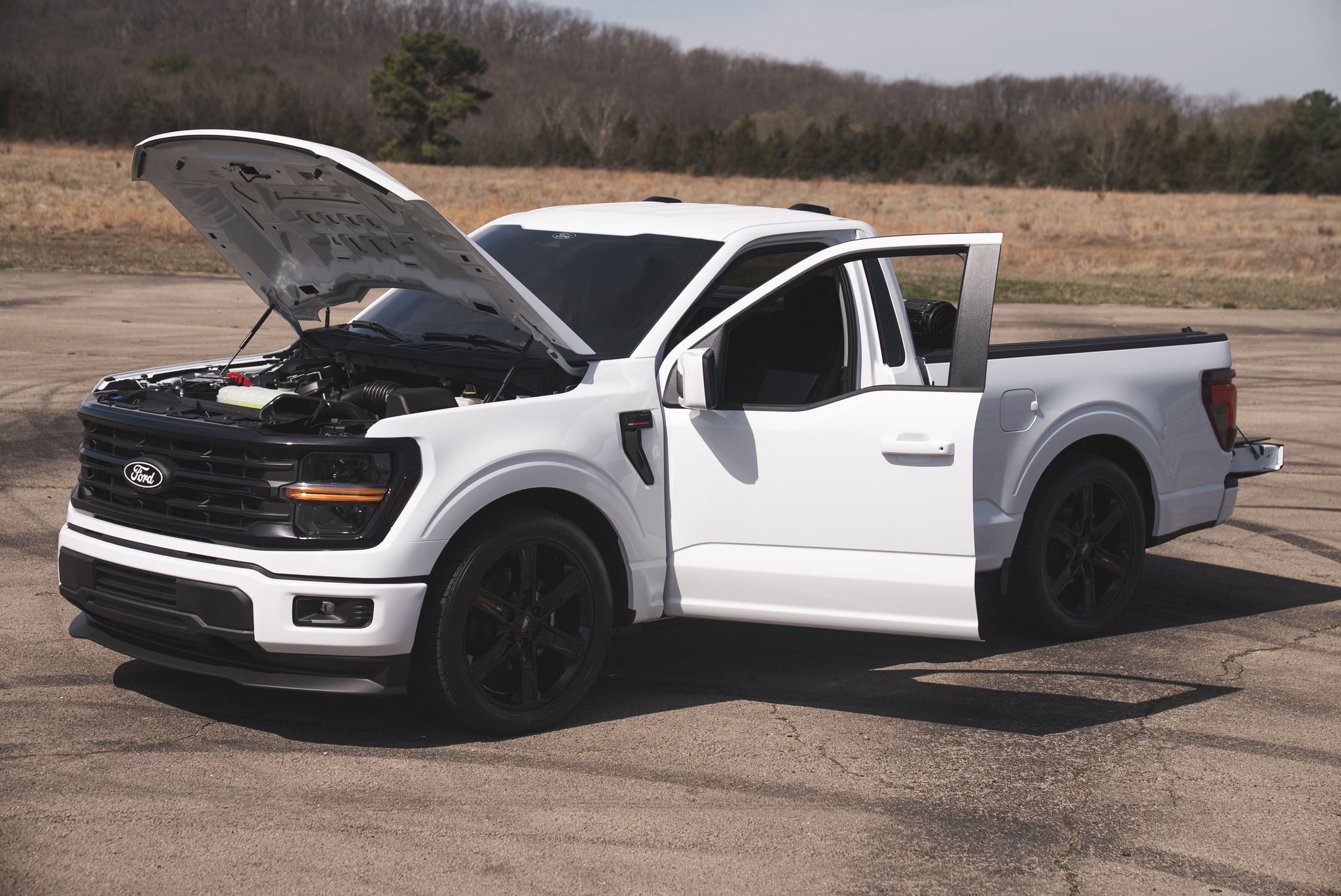 Ford F-150 with its hood and door open after APG upgrades