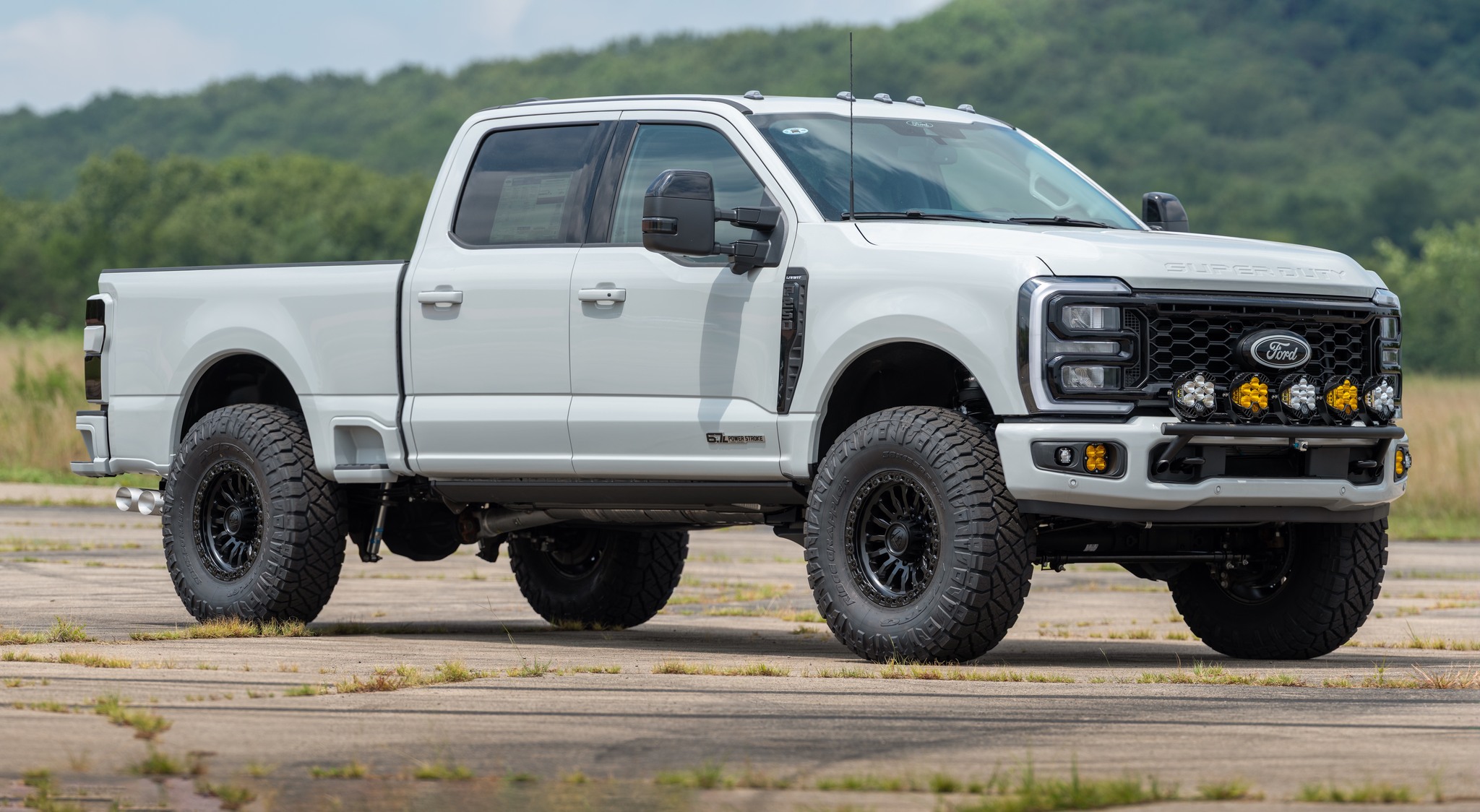 Lifted white Ford Super Duty with APG lighting and wheel upgrades